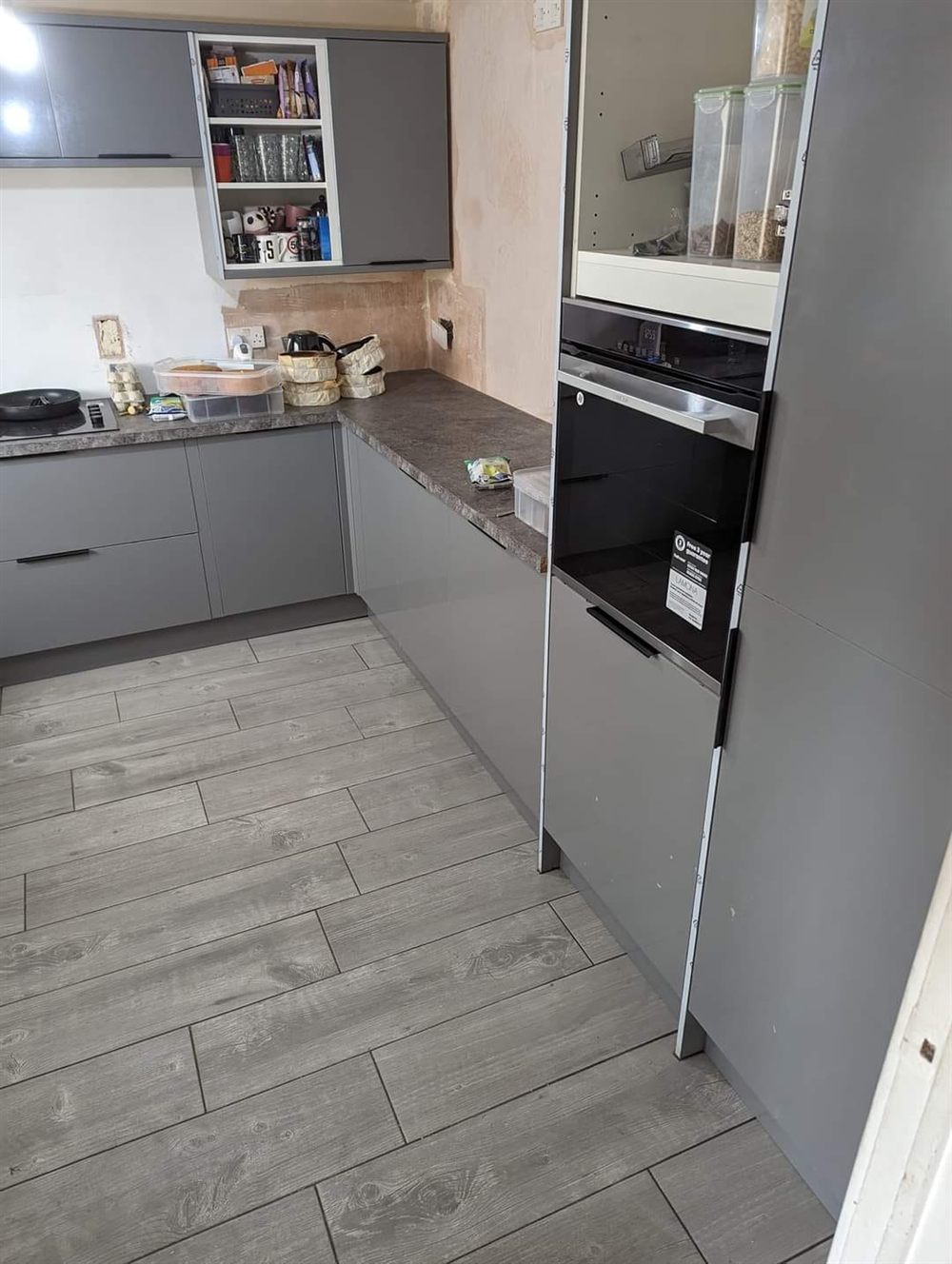 Grey fitted kitchen with built-in oven