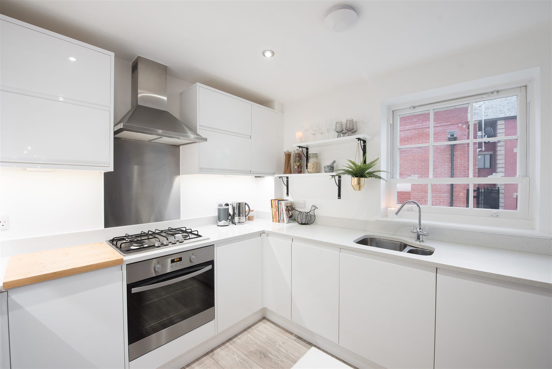 A glossy white modern fitted kitchen