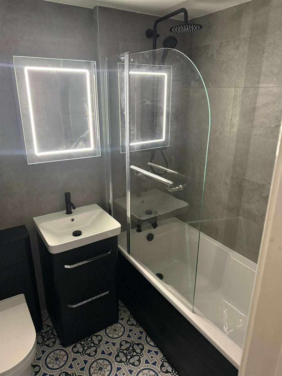 Modern bathroom with LED mirrors and vanity unit fitted by Parker & Dodds