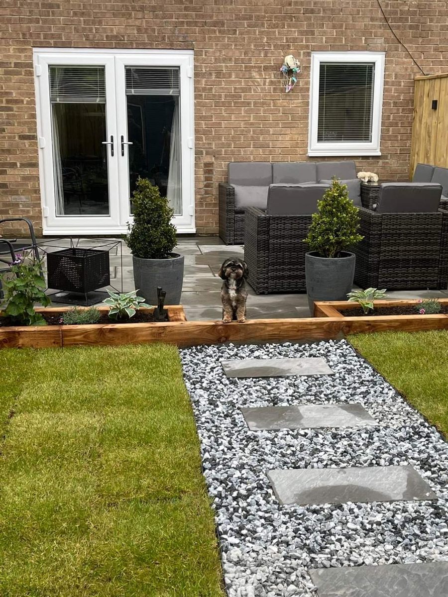 Landscaped garden with new lawn, sleepers and stepping stones by Parker & Dodds