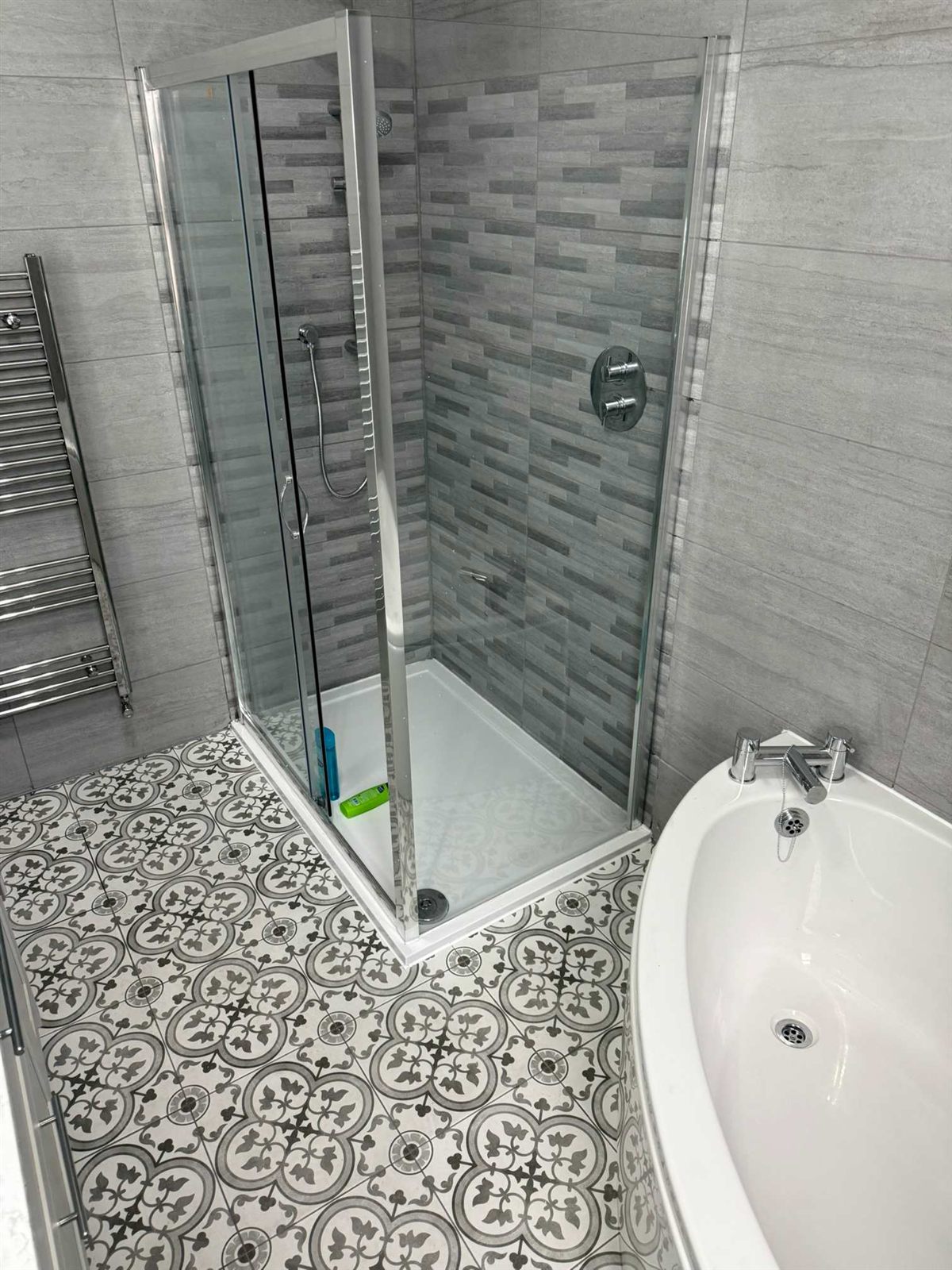 Walk-in shower with patterned floor tiles